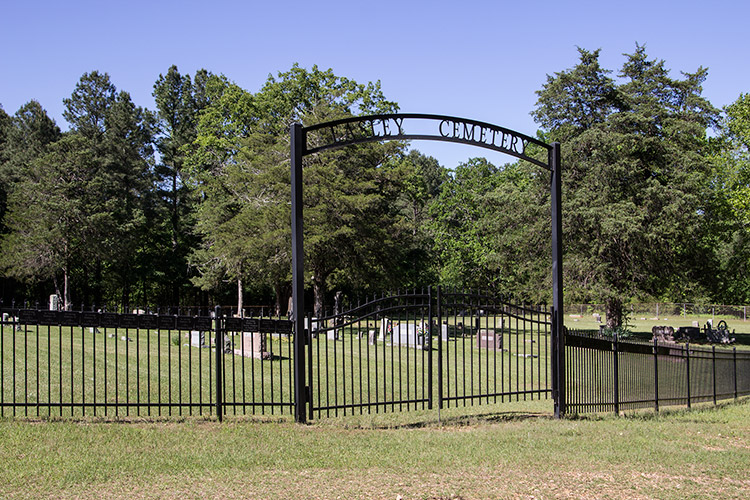 Cemetery with iron fence and arch over double gates
