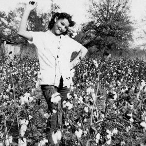 Young white girl dancing in cotton field
