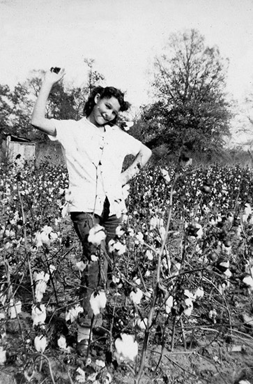 Young white girl dancing in cotton field