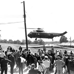 Crowd of people watching a Marine helicopter landing
