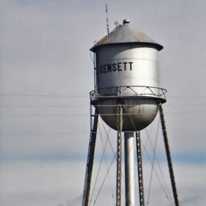 silver water tower with "Kensett" written on it