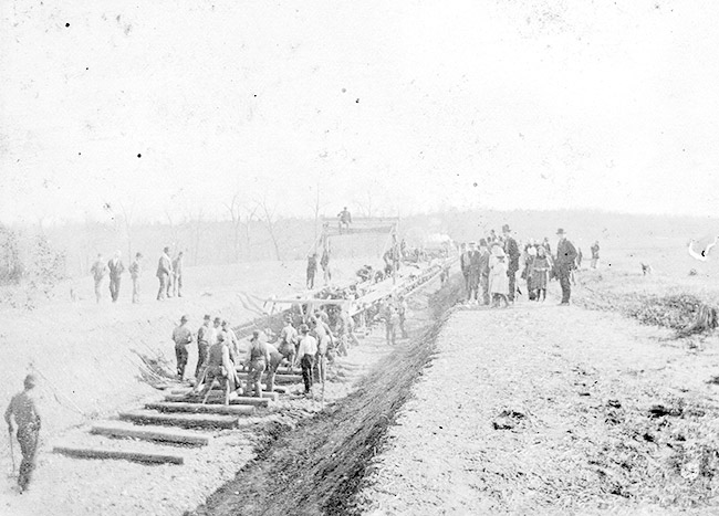 Railroad workers laying tracks