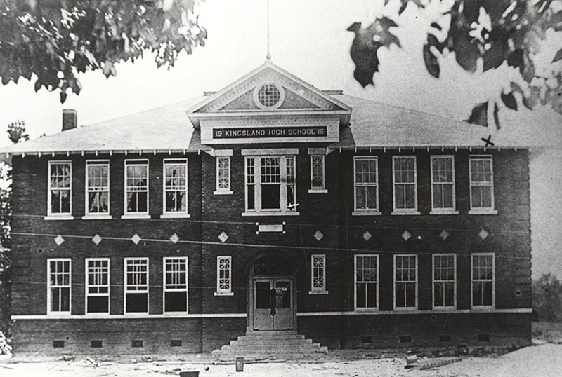 Multistory building with "Kingsland High School" sign above second story windows