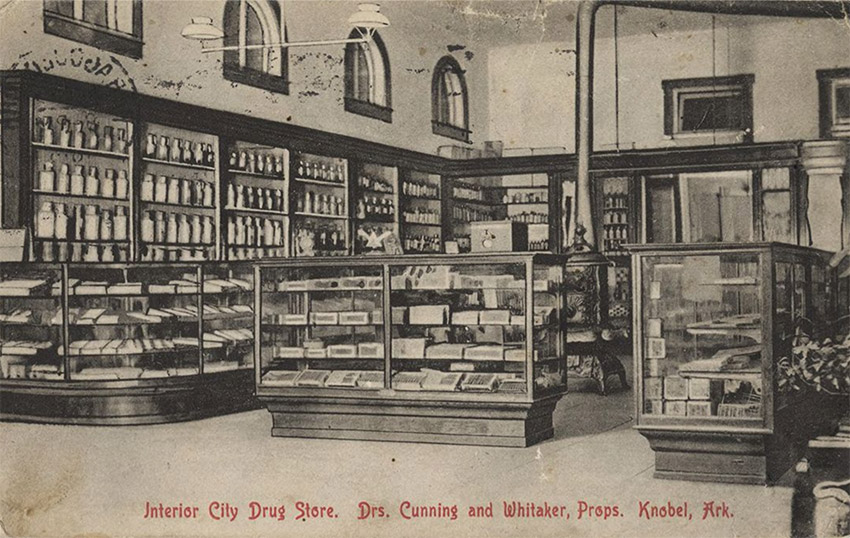 Interior of store with glass display cases and iron stove