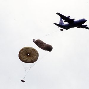 Airplane and objects being dropped by parachute from it