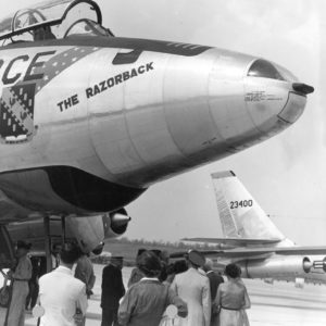 Grounded "U.S. Air Force" jet nicknamed "The Razorback" with spectators at the wheel base