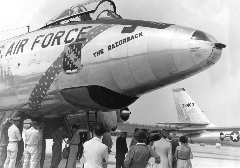 Grounded "U.S. Air Force" jet nicknamed "The Razorback" with spectators at the wheel base