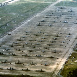 Aerial view of airplanes parked in multiple rows on base
