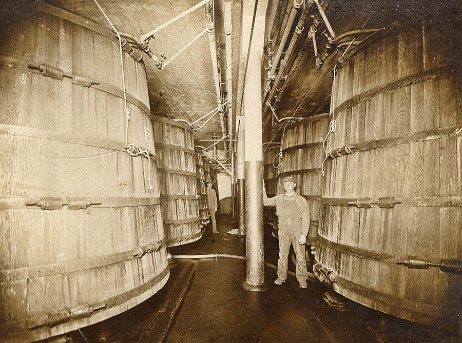 White man in room with large wooden tanks