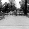"U.S. National Cemetery" iron gates with gravestones beyond it