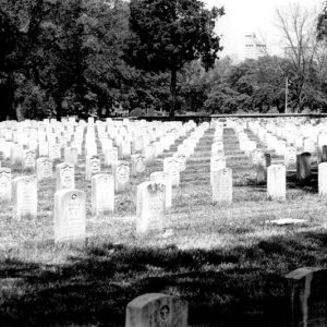 Rows of white gravestones in cemetery