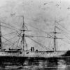 Ship with three masts at sea with flag waving