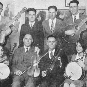 Group of white men and two women with their instruments