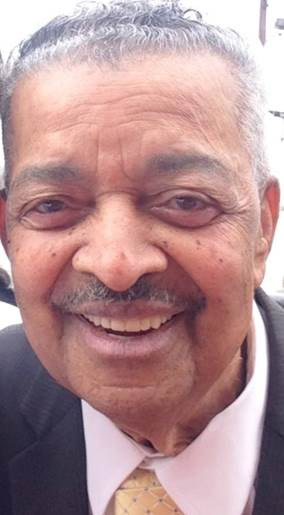 Older African-American man with mustache smiling in suit
