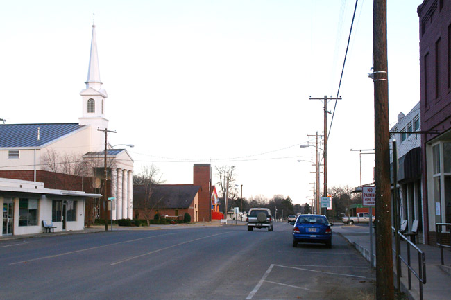 street scene with large steepled church on one side