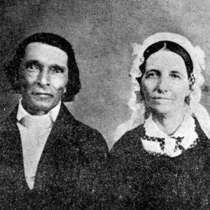 White man and woman wearing a bonnet