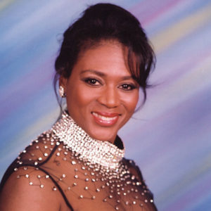 Young African-American woman smiling in dress with jewel-decorated top