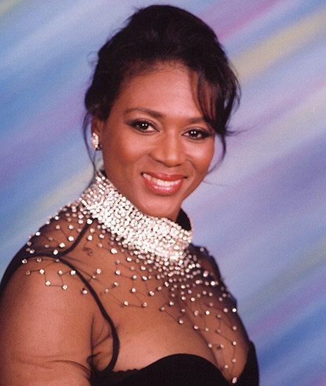 Young African-American woman smiling in dress with jewel-decorated top