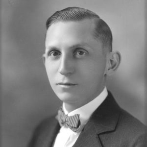 White man in suit with bow tie
