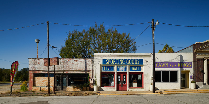 Single-story storefront buildings on street