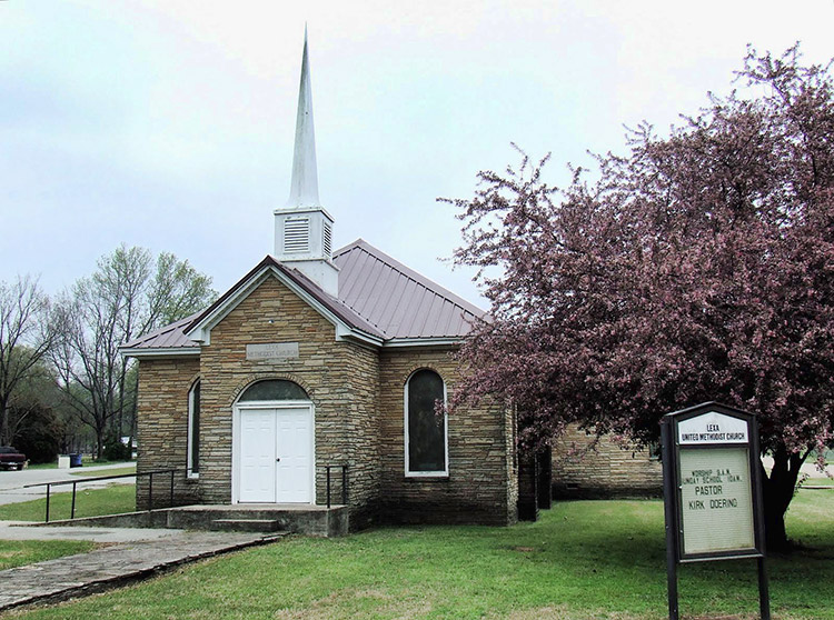 stone church building with steeple and wheelchair ramp
