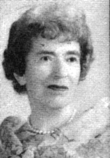 Older white woman with pearl necklace and dress