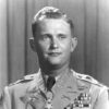 White man smiling in military uniform with medal of honor