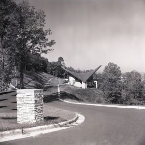 Side view of modern overlook building with curved roof on paved road