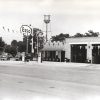 Service station with cars, water tower "Esso. Grand opening today"