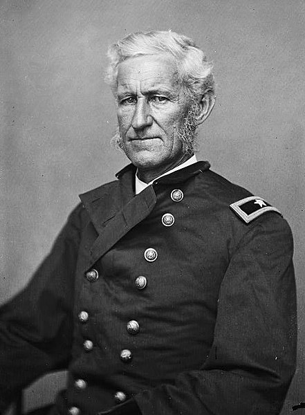 Old white man sitting in military uniform