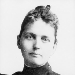 younger white woman in jacket with a high neck and large buttons