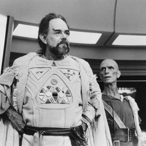 White men in costume and make-up on spaceship set