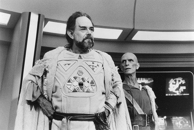 White men in costume and make-up on spaceship set