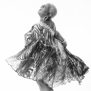 African-American woman with short hair dancing in dress