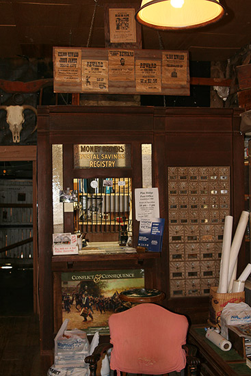 Postman's desk with letter boxes, wanted posters and other artifacts