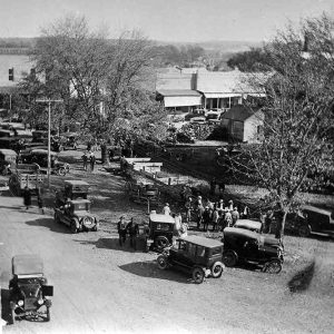 Large number of old cars on streets of downtown square