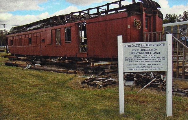 red wooden train car on display with white sign
