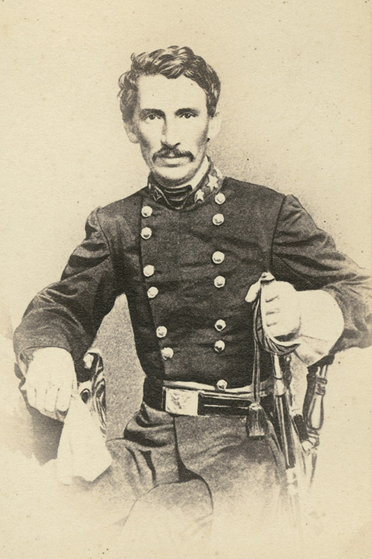 White man with mustache sitting in military uniform with sword