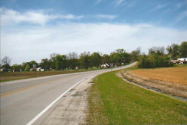 Highway section with buildings and trees in the background