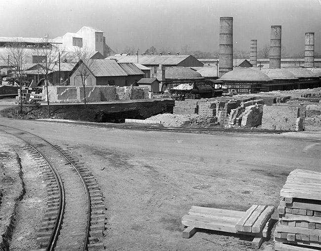 Industrial buildings with smoke stacks bricks and train tracks