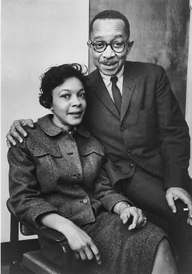 African-American man and woman sitting in chair
