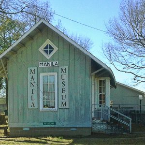 Small depot building with "Manila Museum" sign on its side