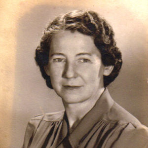 White woman with curly hair in Army nurse uniform