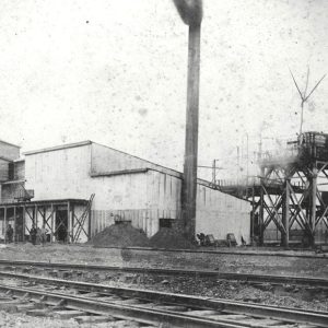 Industrial building in front of multiple sets of railroad tracks