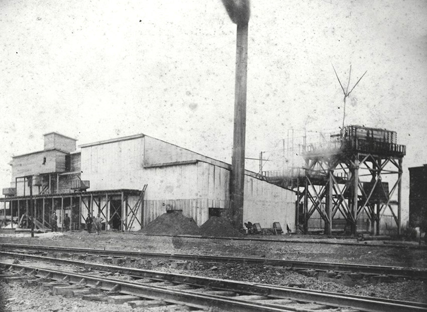 Industrial building in front of multiple sets of railroad tracks