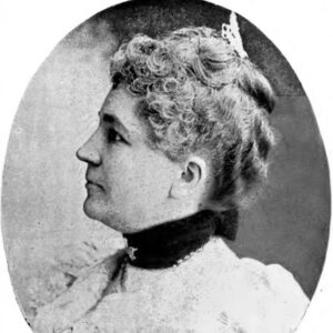 Profile view of white woman with curled hair in dress with collar and hairpin