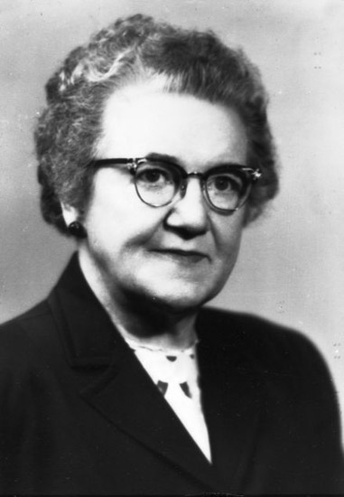 Older white woman with glasses and earrings