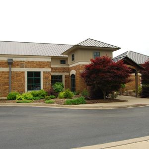 Brick building with covered entrance on parking lot