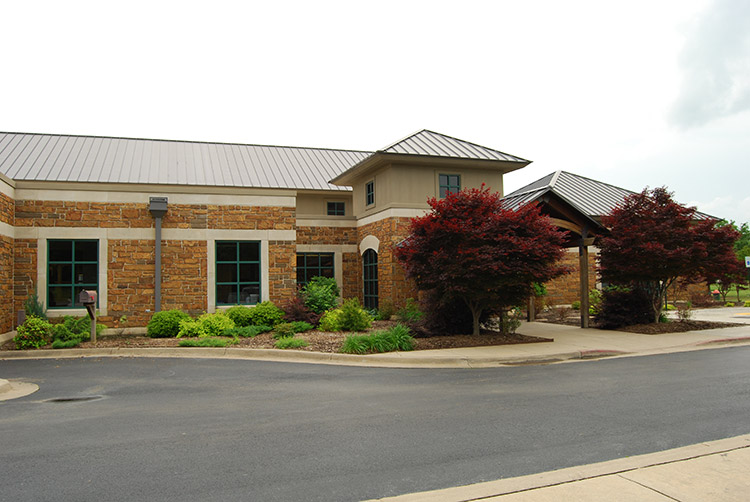 Brick building with covered entrance on parking lot