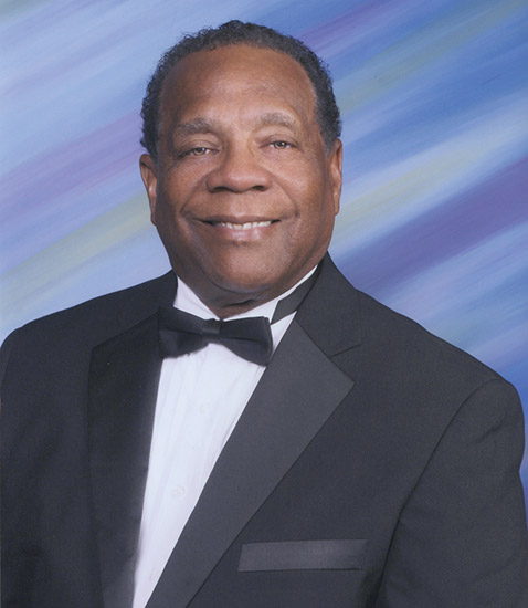 African-American man smiling in suit and bow tie